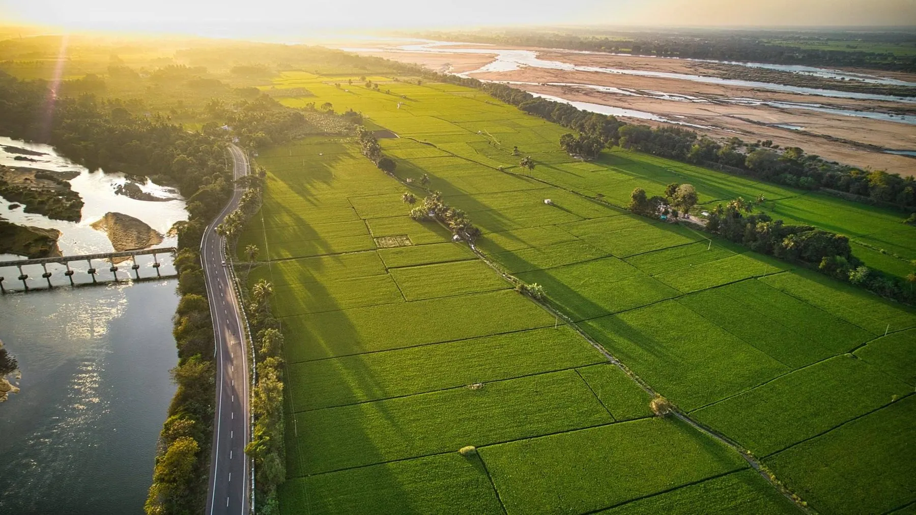 A river winding through green fields, from the air