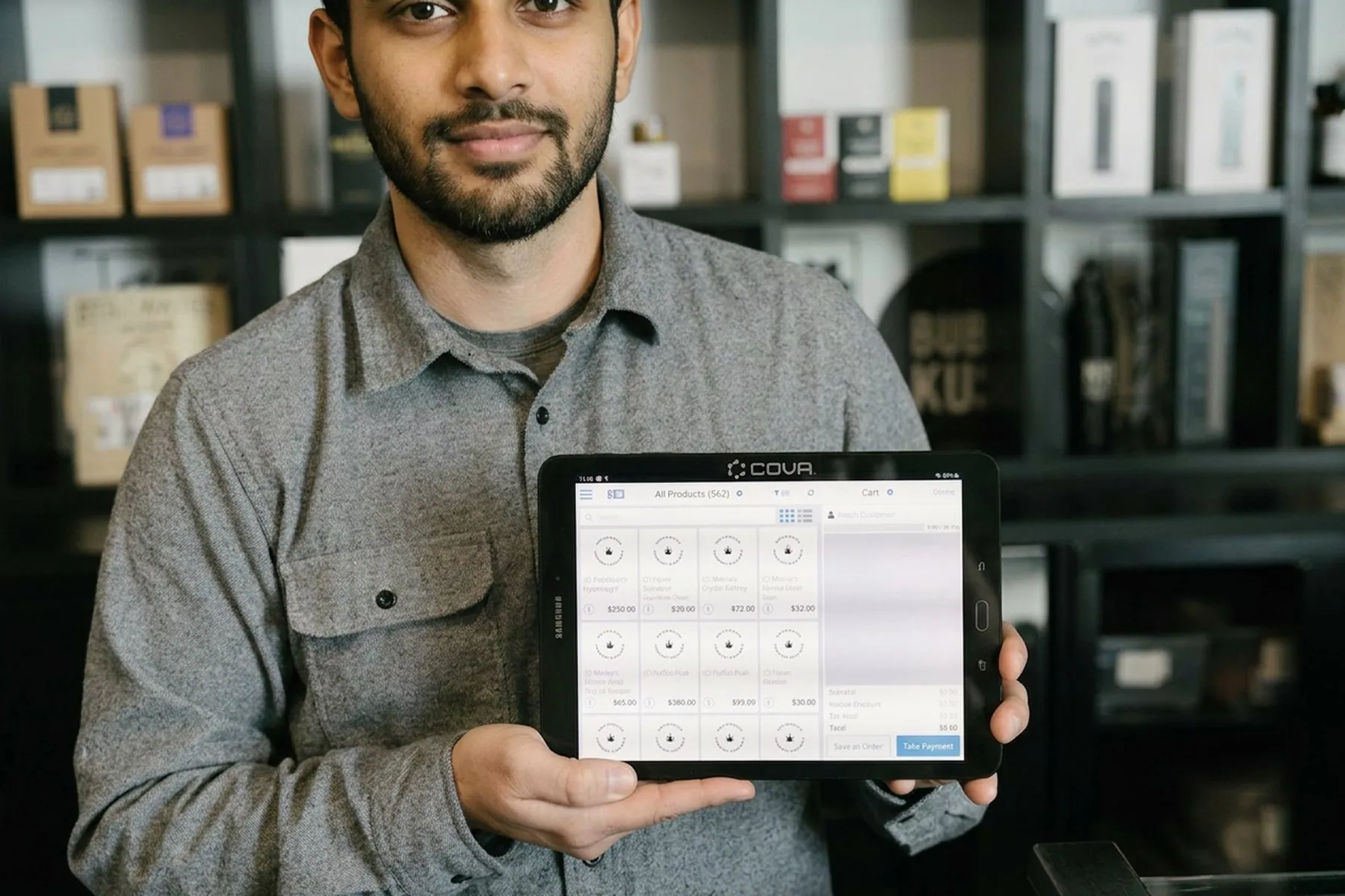 A man holding a tablet showing an app